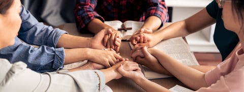 Family praying together at home with gratitude and hope
