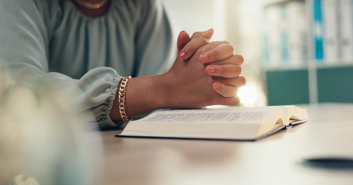 Hands, prayer and bible for religion in home with worship, peace and reading for spiritual guide